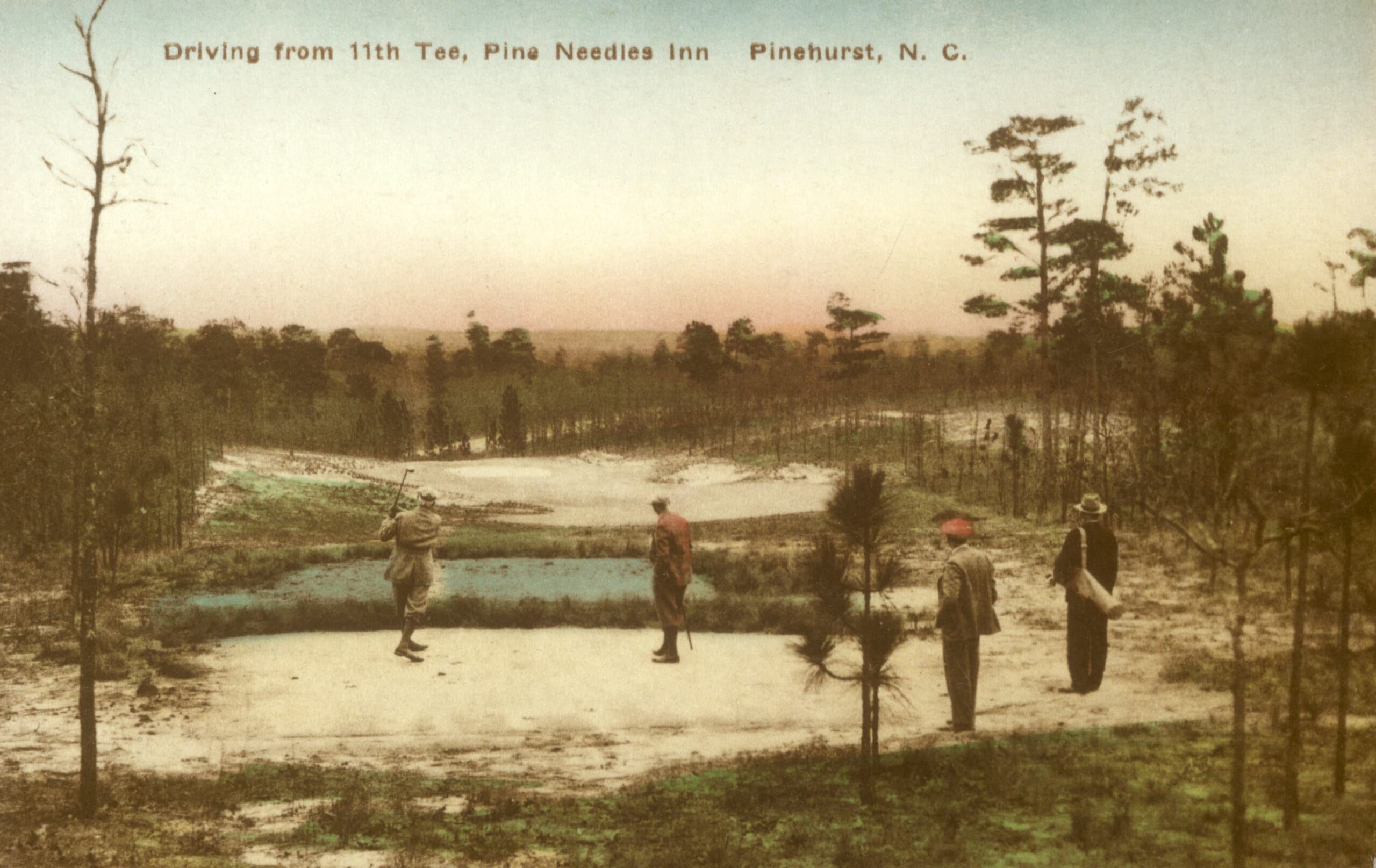 A vintage postcard depicting a golf scene at Pine Needles Inn in Pinehurst, North Carolina. One golfer is preparing to tee off while three others observe from a nearby area, surrounded by trees and a view of the fairway in the background.